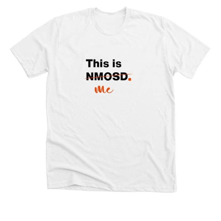 White t-shirt with This is NMOSD in black text. NMOSD is crossed out with orange ink and beneath is the word Me in orange text.