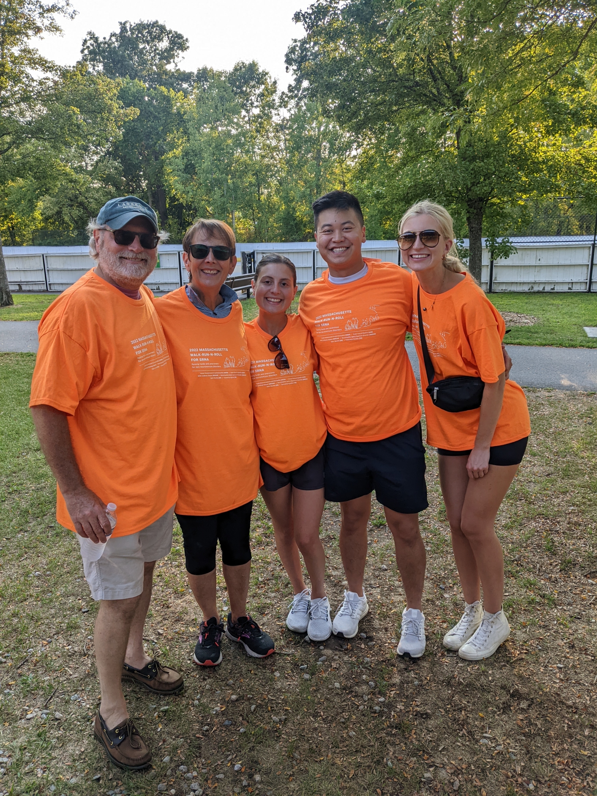 Group of people in bright orange t-shirts at Massachusetts Walk-Run-N-Roll
